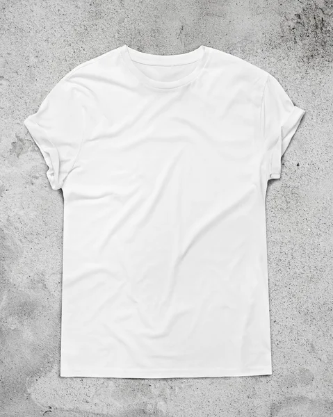 White t-shirt on concrete floor — Stock Photo, Image