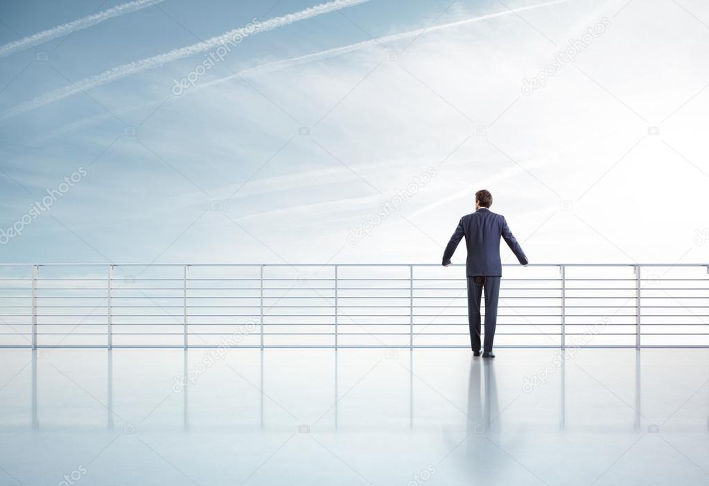Businessman standing on a roof
