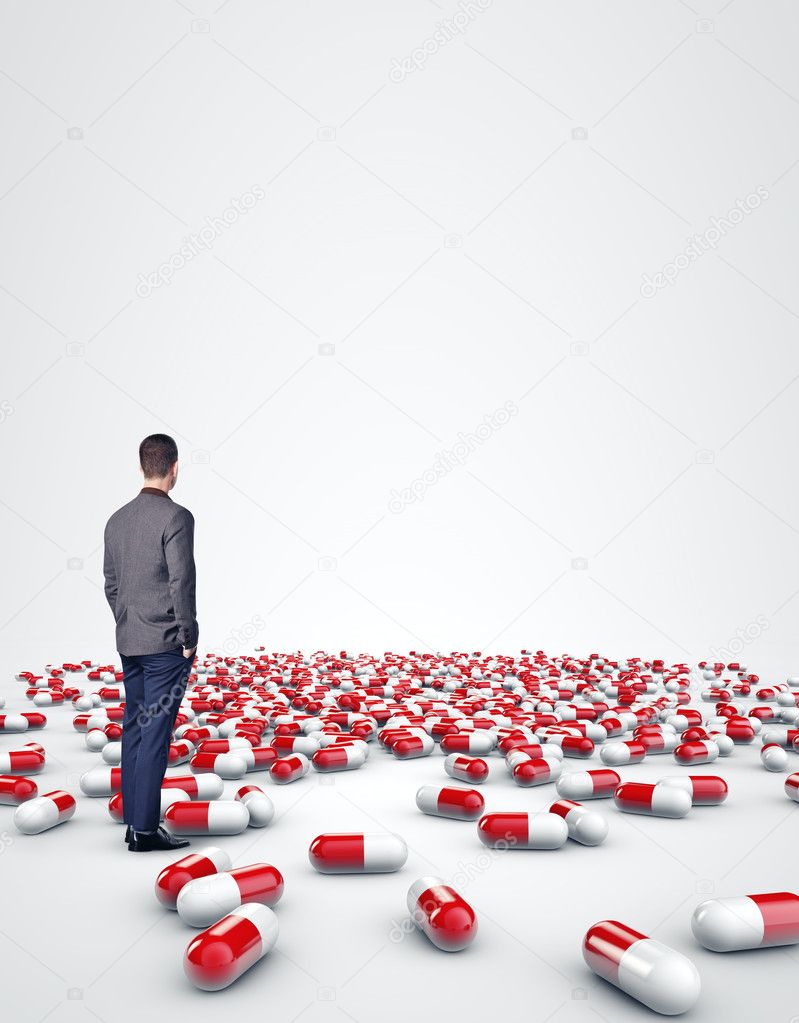 Man standing among pills