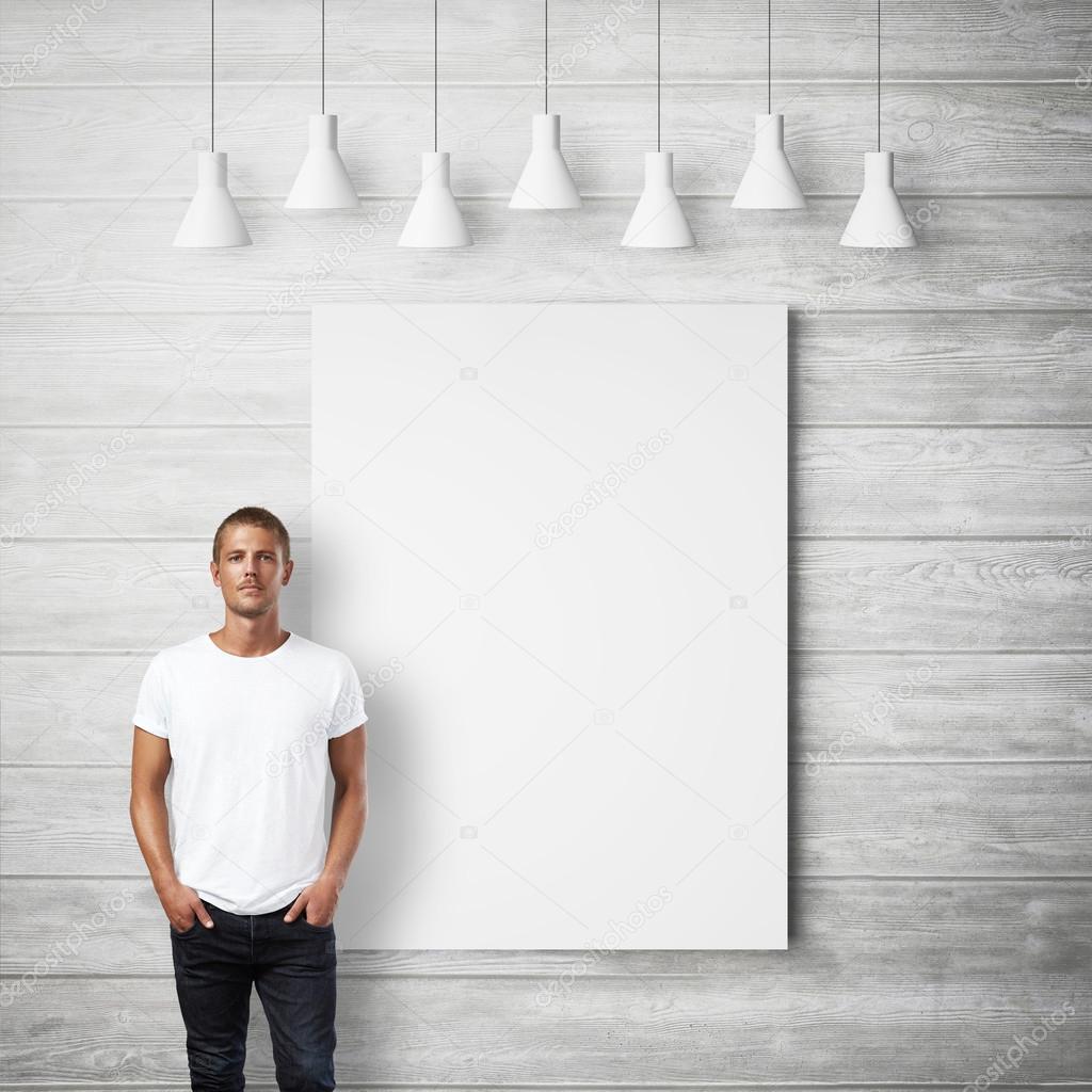 Man and white poster on a wall