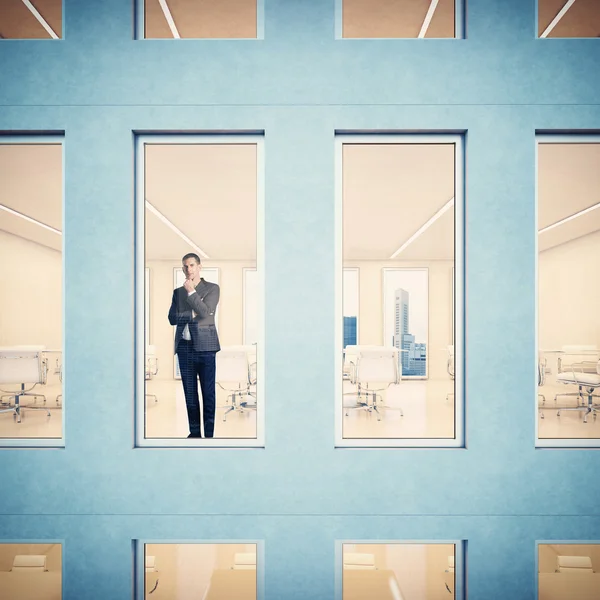 Businessman looking through window — Stock Photo, Image