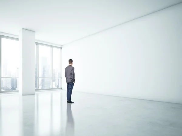 Man looking at white wall — Stock Photo, Image