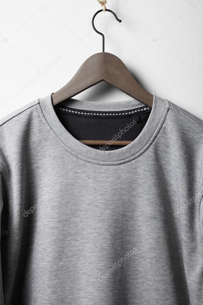 Jumper hanging on white wall — Stock Photo © kantver 53802673