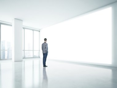 Man looking at white panel