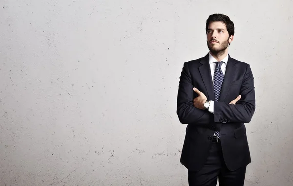 Businessman on bright concrete background — Stock Photo, Image