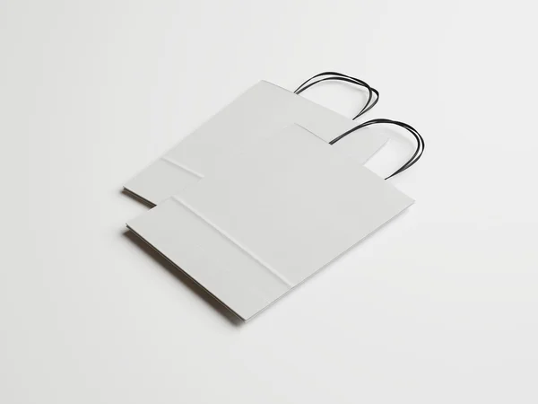 Dwie torby papierowe białe z czarnymi uchwytami — Zdjęcie stockowe