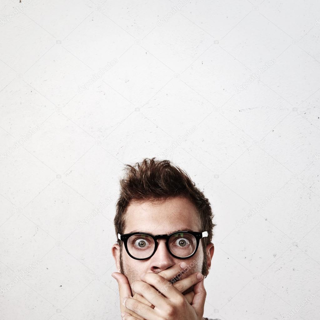 Surprised young man wearing eyeglasses