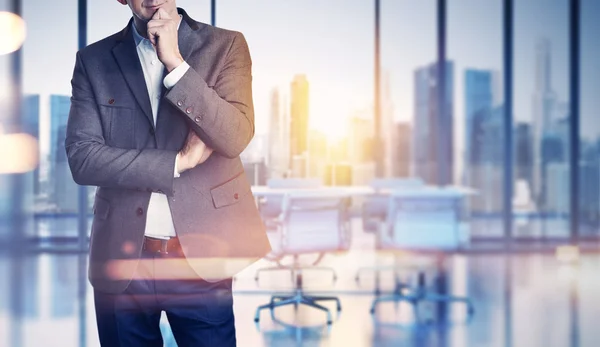 Businessman on blurred office background — Stock Photo, Image