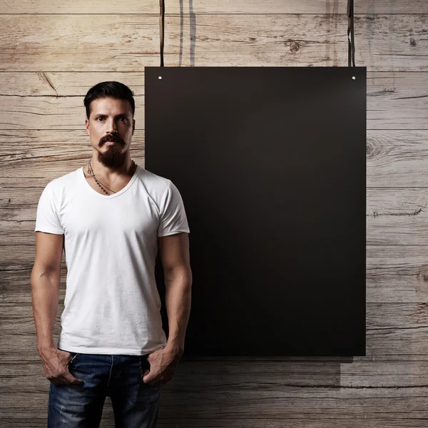 Bearded guy with blank poster — Stock Photo, Image