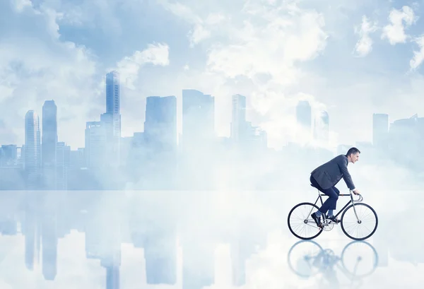 Businessman riding bicycle — Stock Photo, Image