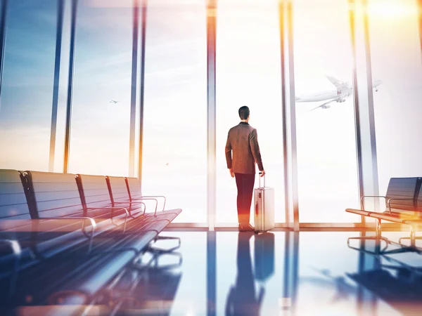 Businessman over airport window — Stock Photo, Image