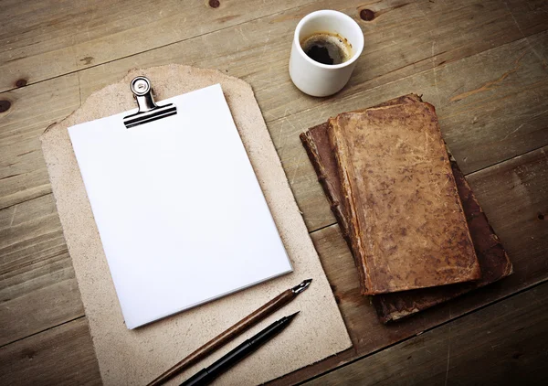 Books, cup of coffee and vintage clipboard — Stock Photo, Image