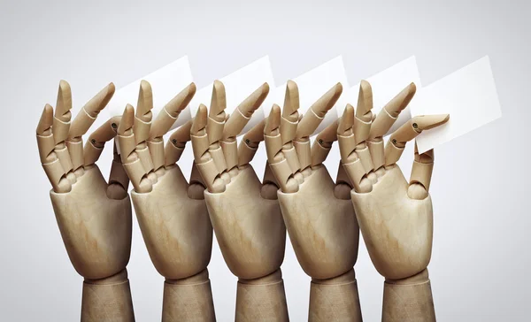 Wooden hands with cards — Stock Photo, Image