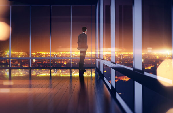 Business man in suit looking at the night city. 3d rendering
