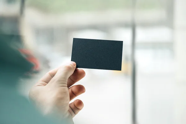 Hand holding business card