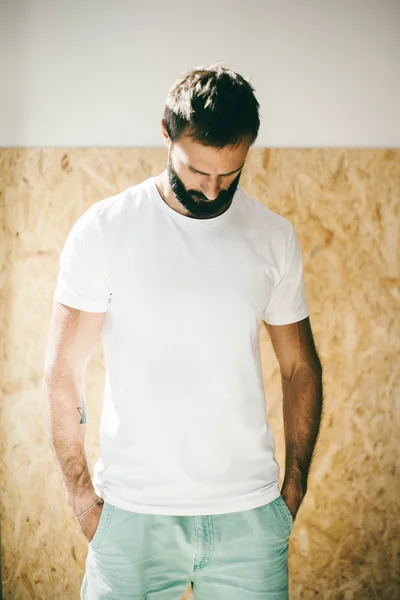 Mockup of a bearded man wearing white tshirt and green shorts — Stock Photo, Image