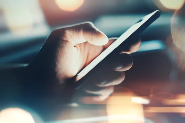 Closeup of hand using smartphone with effects — Stock Photo, Image