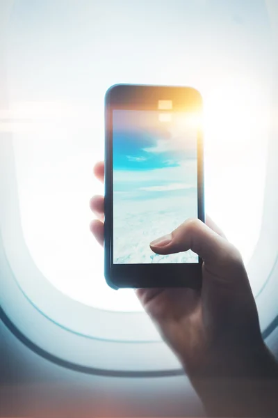 Mock up of girl handing smartphone in hands, private jet — Stock Photo, Image