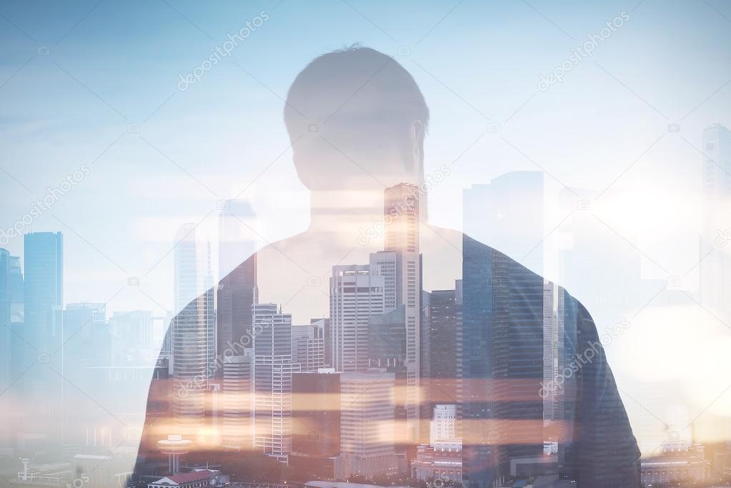 Double exposure of man and city on the background