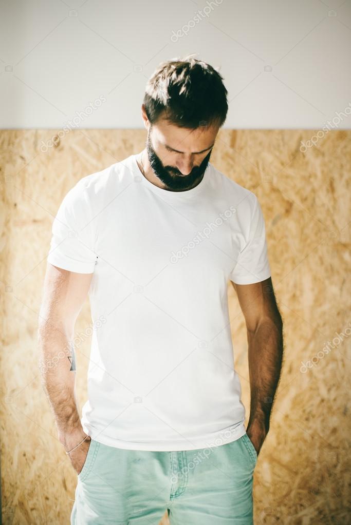 Mockup of a bearded man wearing white tshirt and green shorts