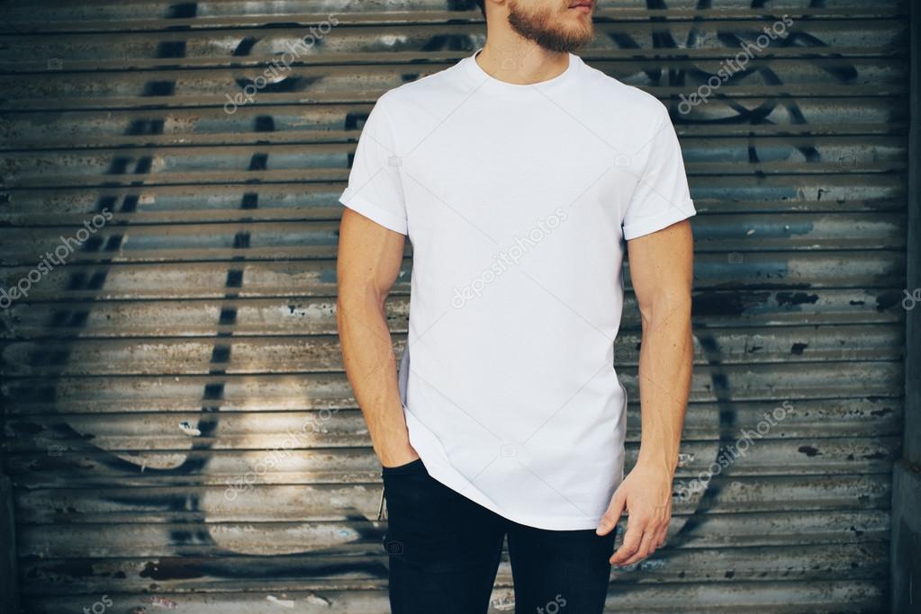 man in white t-shirt and blue jeans