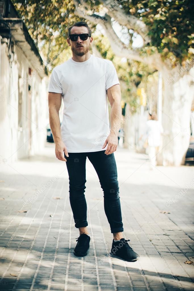 guy wearing white t-shirt and jeans