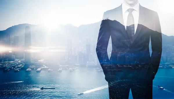 Multi exposure of young business man in the modern city on background — Stock Photo, Image