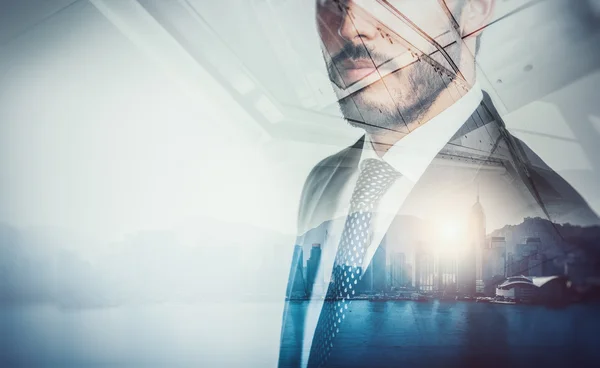 Close-up portrait of businessman. Double exposure city at sunrise