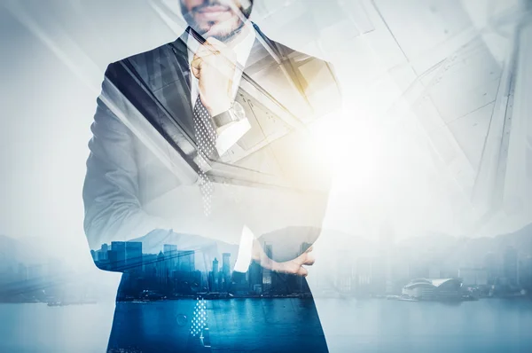 Photo of businessman wearing suit and thinking. Double exposure city at sunrise. Horizontal — Stock Photo, Image