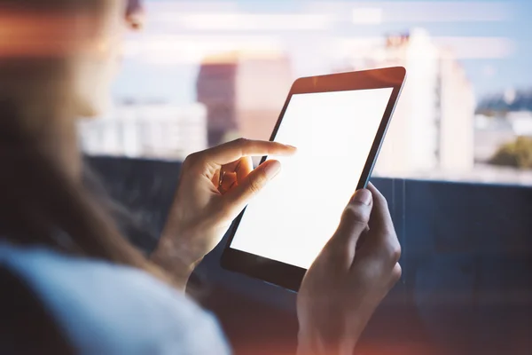 Young girl holding tablet in a hand and touching the screen — ストック写真