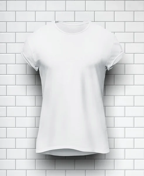 White tshirt isolated on the wall of bricks background — Stock Photo, Image