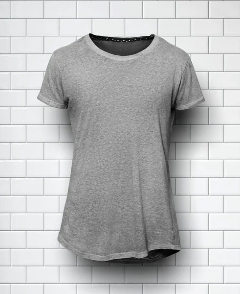 Gray tshirt isolated and wall of the bricks background — Stock Photo, Image