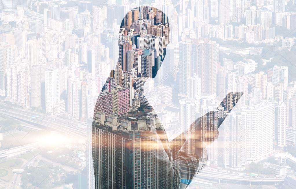 Double exposure of city and man using digital tablet. Horizontal