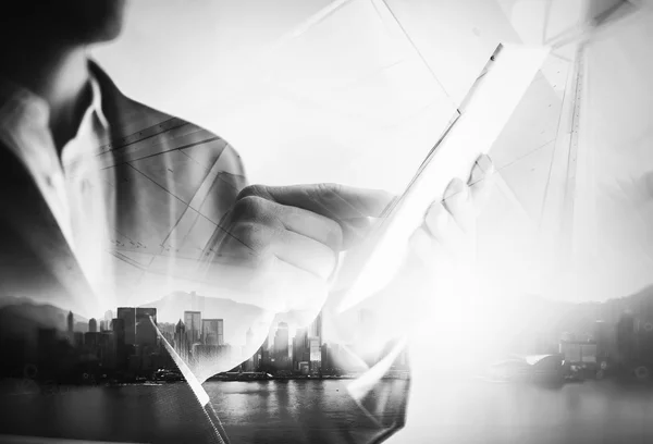 BW double exposure of city and business man using digital tablet. — Zdjęcie stockowe