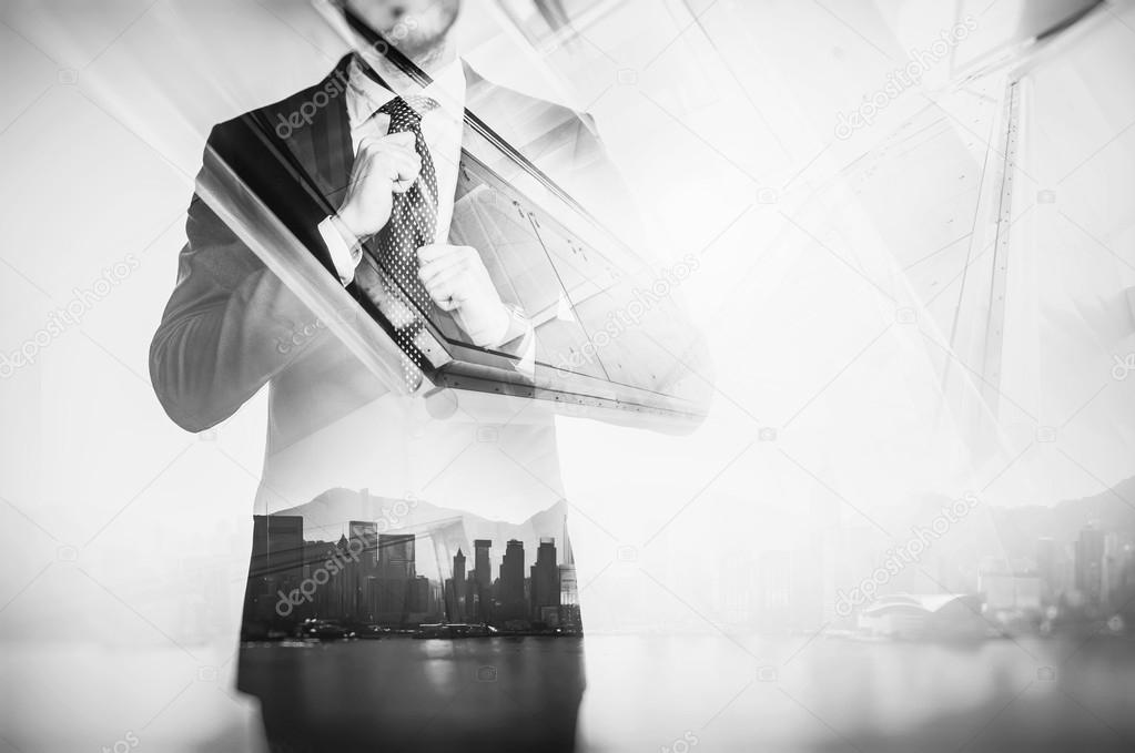 Close-up portrait of businessman straightens his own tie. Double exposure city at sunrise. Black and white