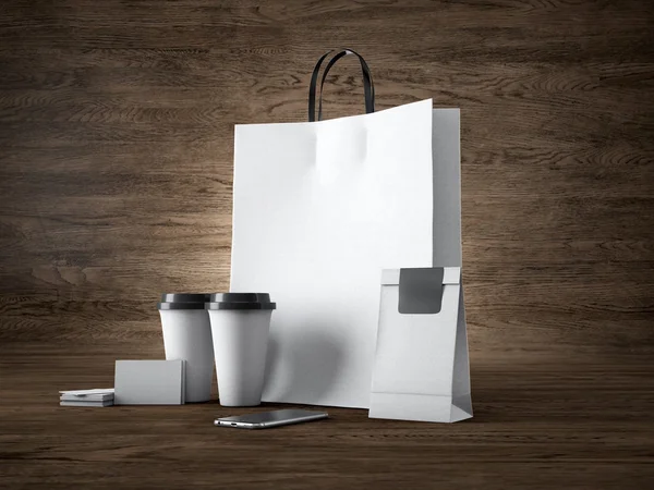 Набор белых сумок для покупок, две чашки кофе, визитные карточки. Деревянный фон. 3D рендеринг — стоковое фото