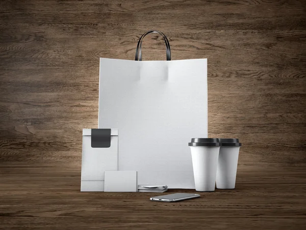 Set of white craft shopping bag, two coffee cups, business cards and generic design smartphone. Wood background. 3d render — 图库照片