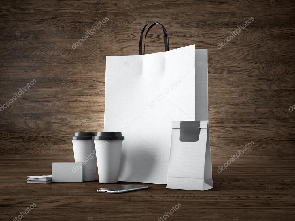 Set of white craft shopping bag, two coffee cups, business cards. Wood background. 3d render