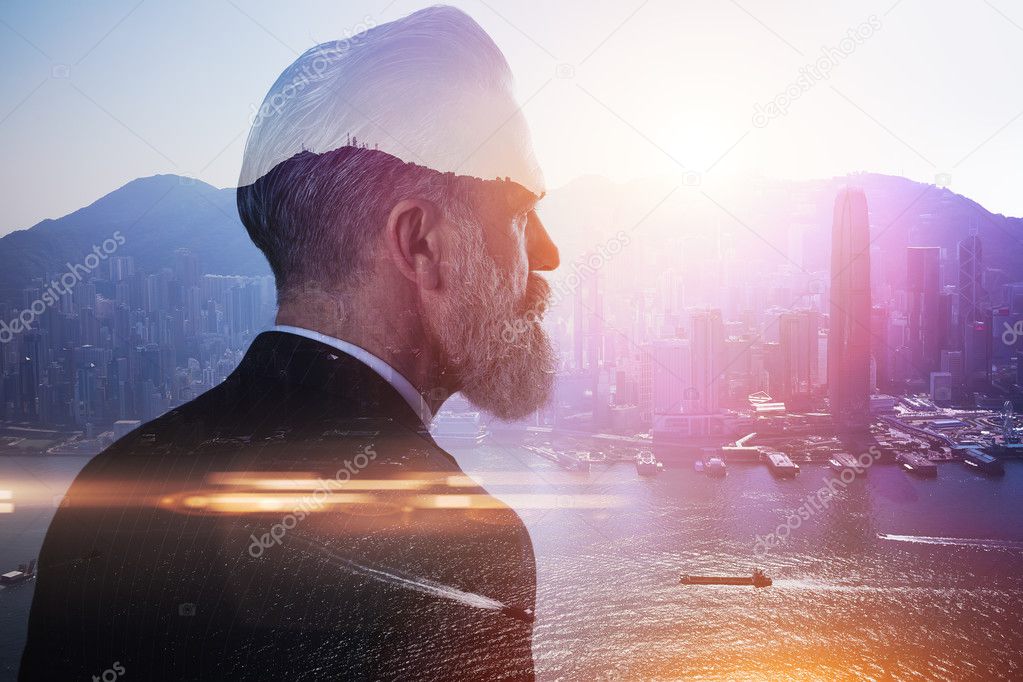 bearded businessman and contemporary city on the background.