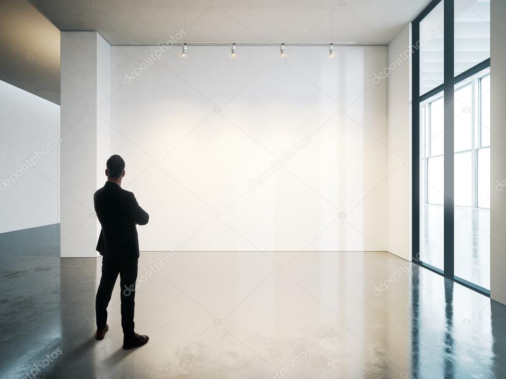 Businessman in blank museum