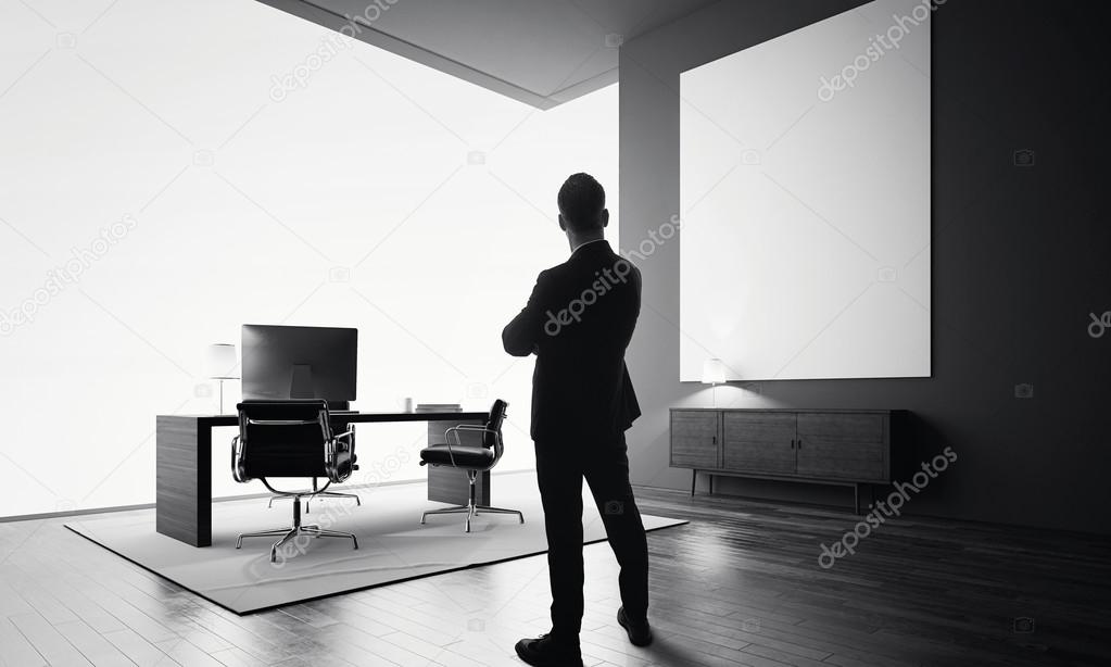 Businessman stands in modern office