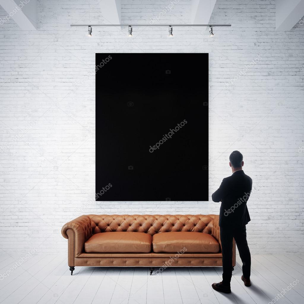 Man looking at black poster