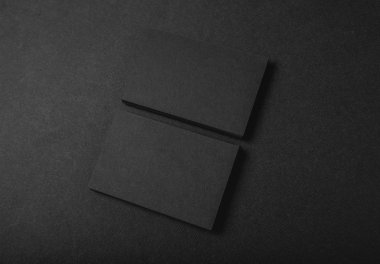 Photo of two stack Of blank black business cards on textile background