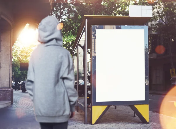 Zdjęcie dziewczyna patrząc w puste lightbox na przystanek autobusowy. Poziome — Zdjęcie stockowe