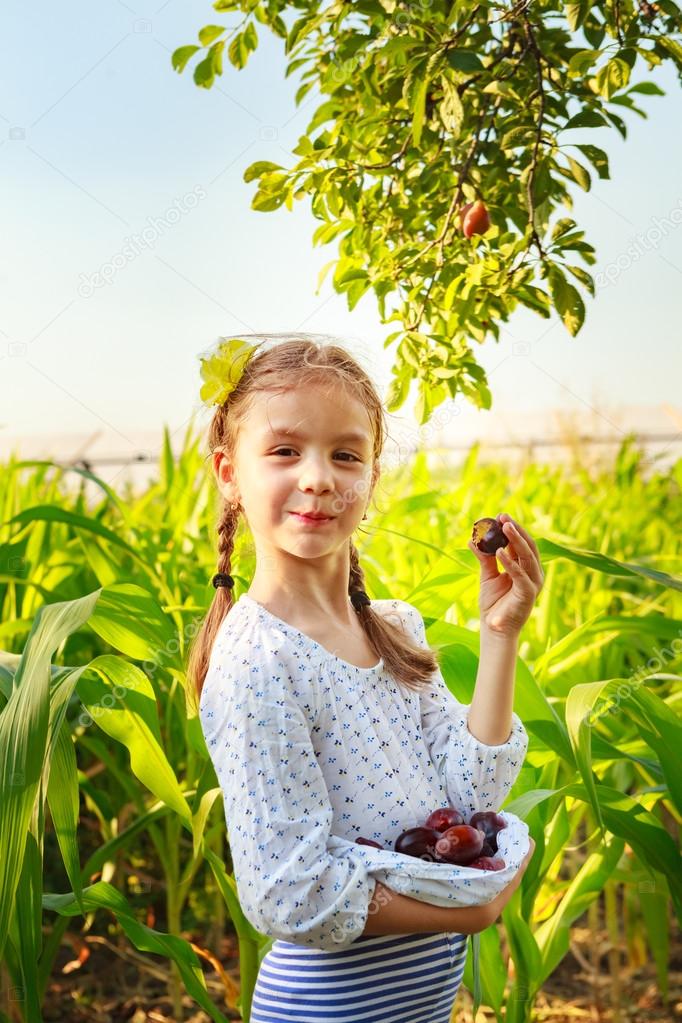 Girl eating plums
