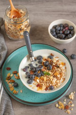 Müsli, yoğurt, muz ve yabanmersinli kahvaltı.