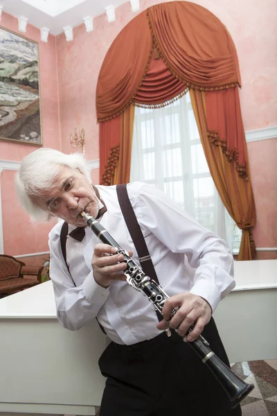Aging musician plays the clarinet — Stock Photo, Image