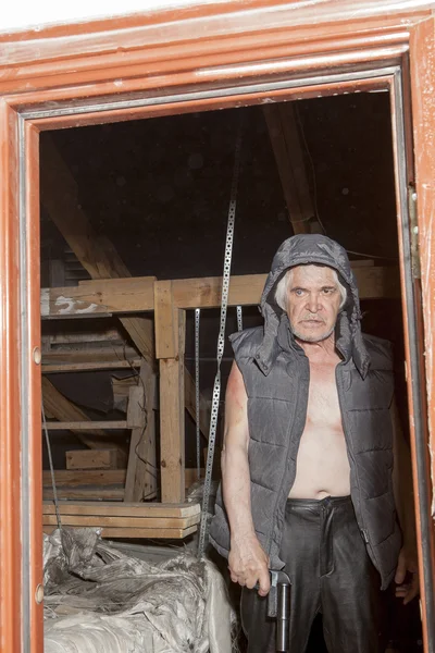 Armed robber with a gun in the attic — Stock Photo, Image