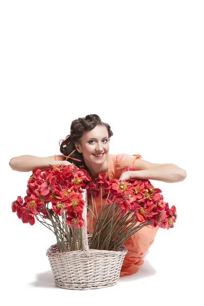 Woman with basket full of flowers — Stock Photo, Image