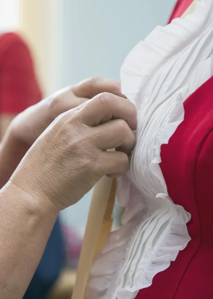 Designer adjusting dress on model — Stock Photo, Image